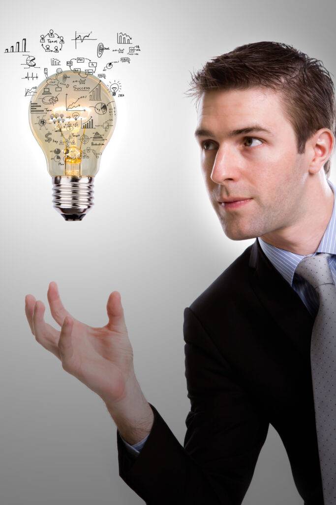 Concentrated Businessman Looking Light Bulb With Diagrams 683x1024