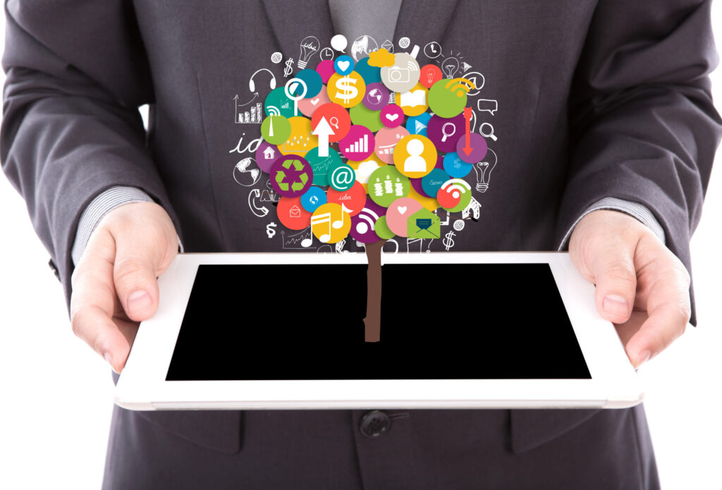 businessman holding tablet with colorful icons scaled.jpg
